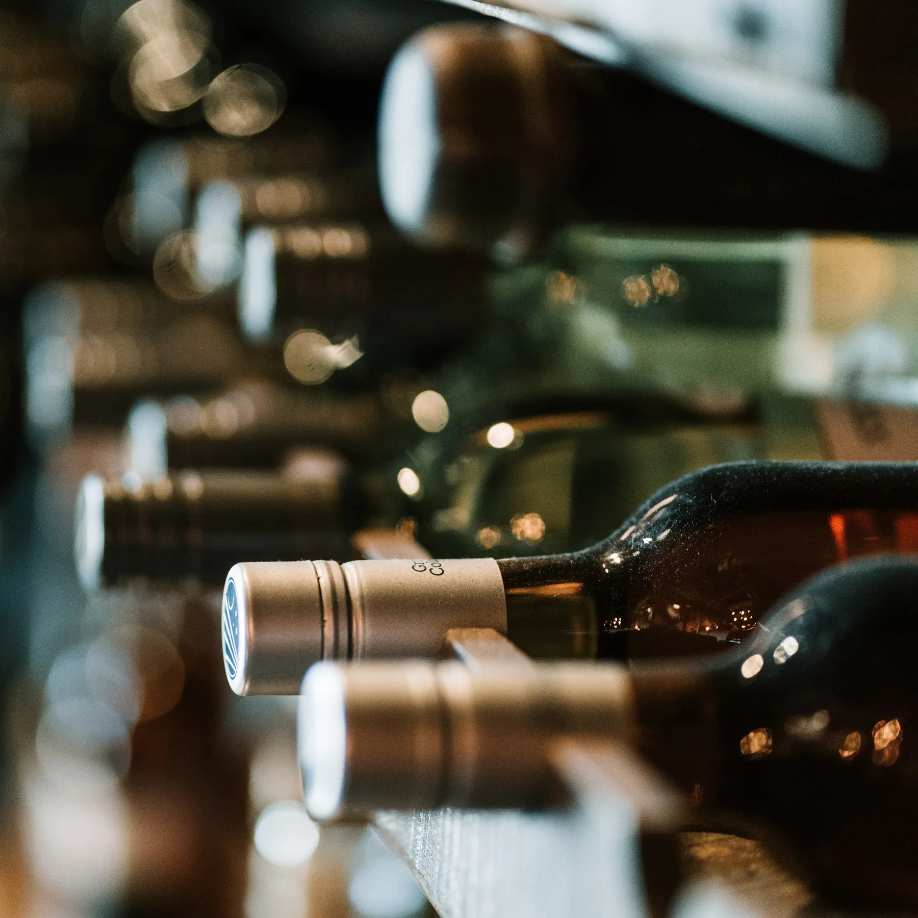 A row of wine bottles lined up for a tasting